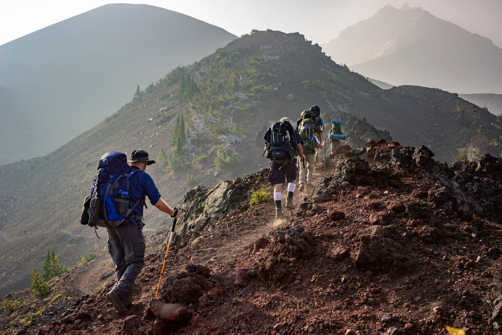 Group of hikers walking along a mountain ridge